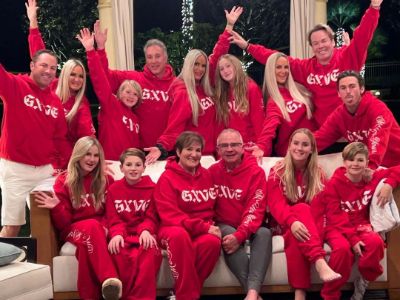The entire Dahm family is wearing an identical red hoodie in this family picture.